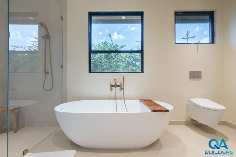 Bathroom with a freestanding tub, wall-hung toilet and black-framed windows, San Jose