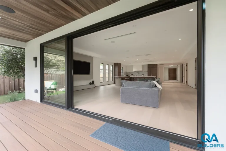 Covered deck opening through a wide sliding door into the open-plan living area, San Jose