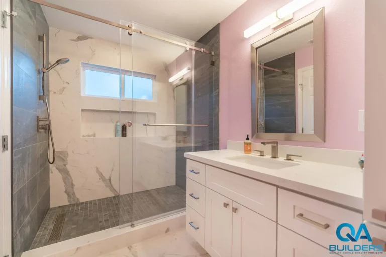 Remodeled San Jose bathroom with marble-look shower and white vanity