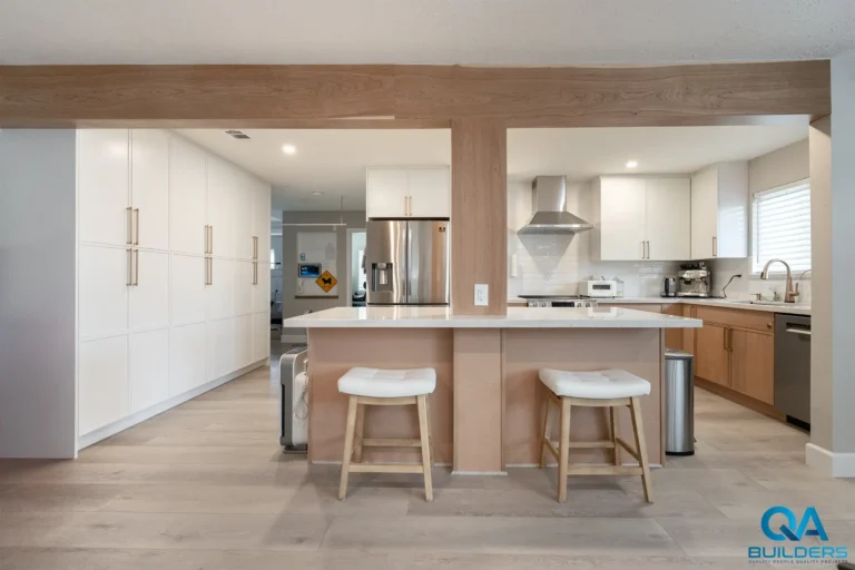 Two-tone kitchen remodel with quartz island and wood beam in San Jose