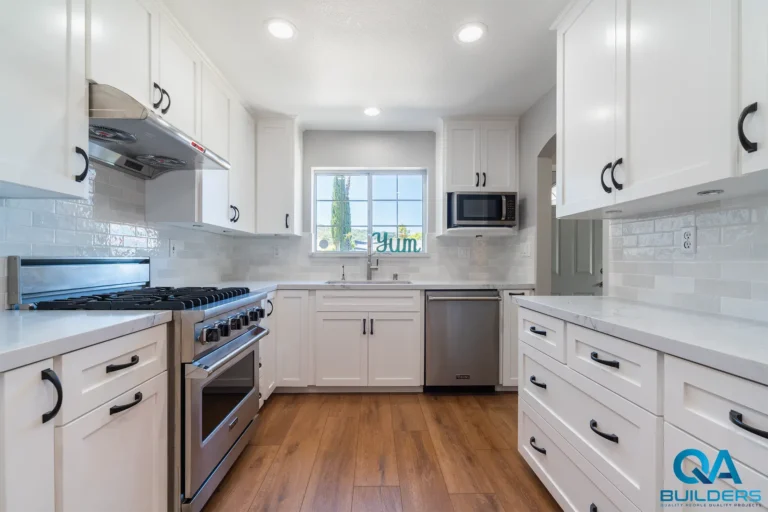White shaker kitchen with a pro range, subway tile backsplash and black pulls, San Jose
