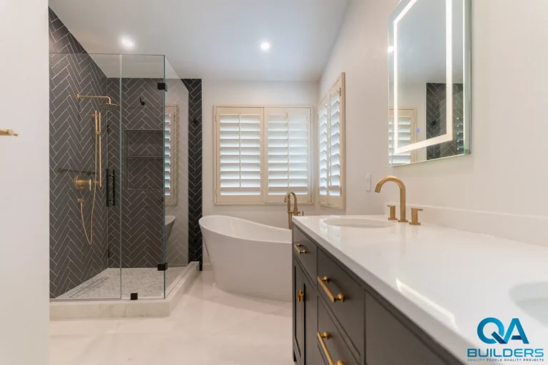 Primary bathroom with herringbone tile shower and freestanding tub in San Jose