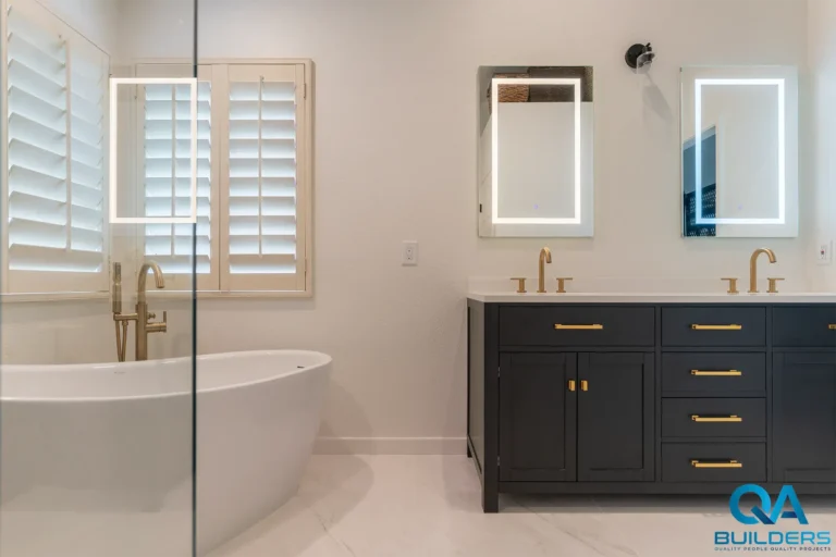 Primary bathroom with a freestanding tub, charcoal double vanity and gold-tone fixtures, Chelsea Crossing, San Jose