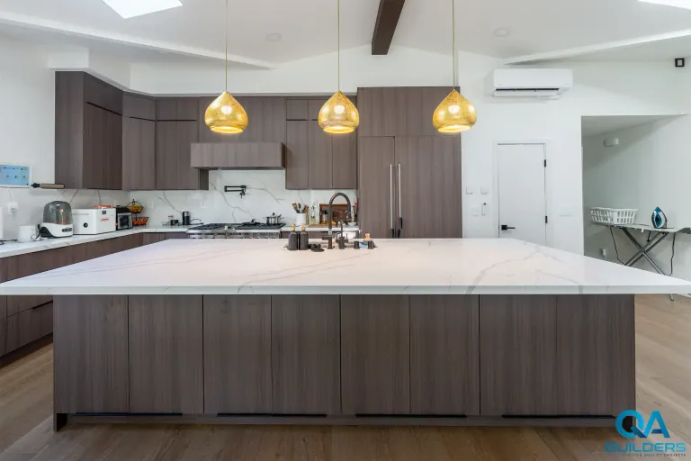 New kitchen with long quartz island in a San Jose home addition
