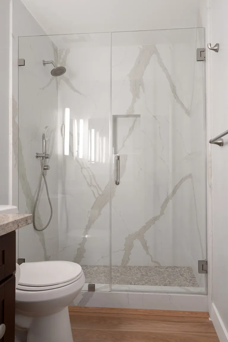 Walk-in shower with marble-look slab walls in a Cupertino townhouse renovation