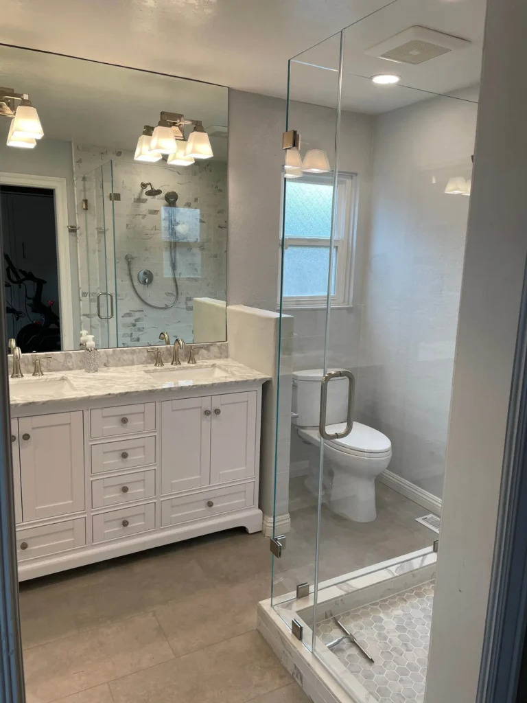 Guest bathroom remodel with glass shower and white vanity