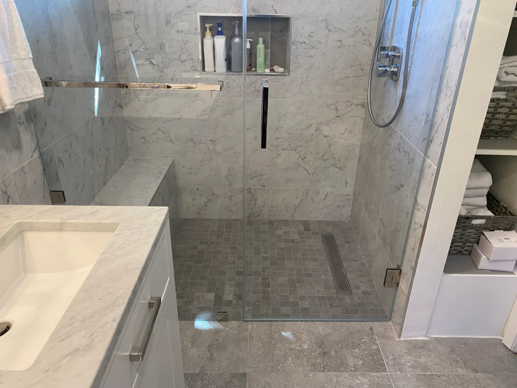 Curbless shower with linear drain and marble-look tile in Palo Alto