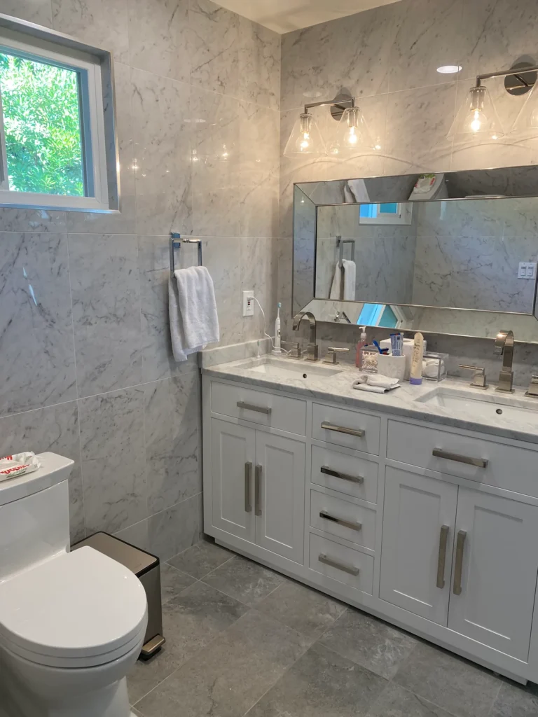 White double vanity and marble-look walls in Palo Alto bathroom remodel