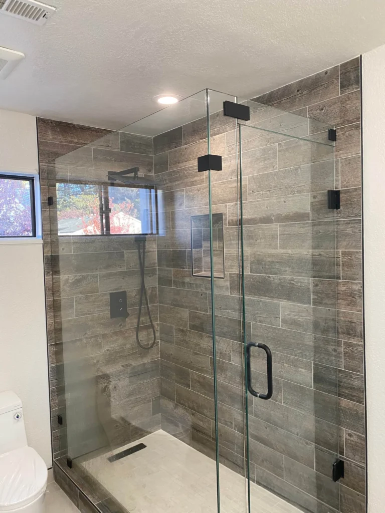 Walk-in shower with wood-look tile and frameless glass in Sunnyvale