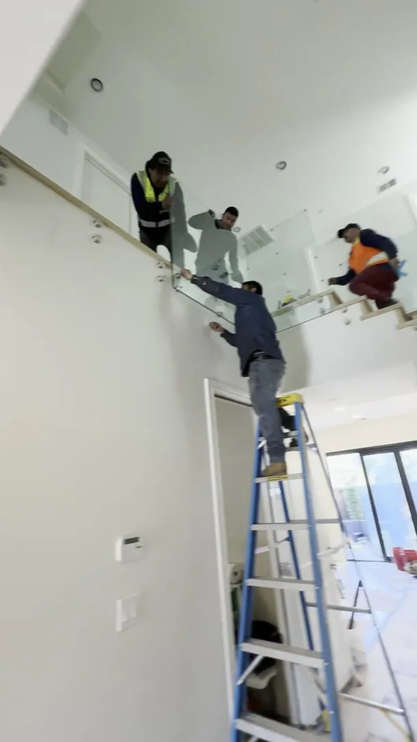 Crew installing the glass stair railing in San Jose