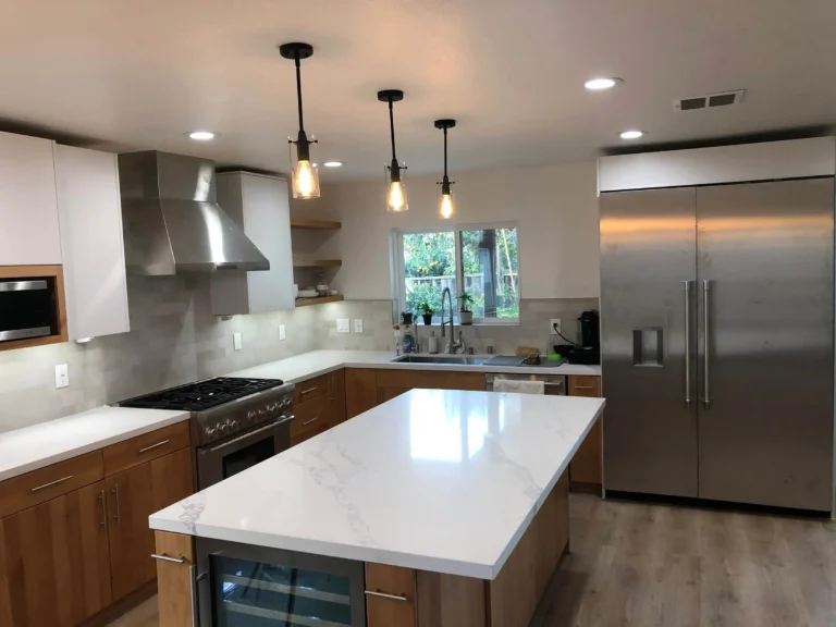 Kitchen remodel with wood cabinets, quartz island and stainless appliances
