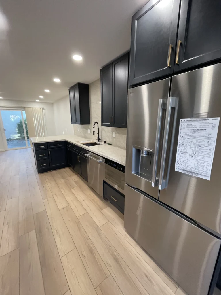 Remodeled San Jose kitchen with dark shaker cabinets, stainless appliances and wood-look floors